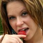 18 year old Kandie gets naked and enjoys some strawberrys in a park