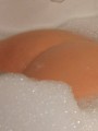Cute Ruby loves to show off her tight round ass in a bubble bath