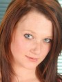 Cute redhead strips out of her sexy red bra and panties