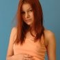 Kori nipping in her peach top